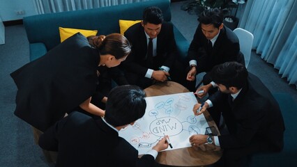 Top view of skilled diverse business people planning project by using mind map to brainstorm...