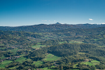 The mountains, forests, pastures and villages where Parmigiano-Reggiano is produced. Provinces of Modena and Reggio Emilia, Italy. Taken from the Pietra di Bismantova; Mount Cimone on background