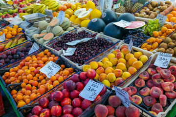 Fresh fruit at the morning street market in Italy. Cherries, melon, bananas - vitamins are cheap....