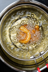 Close-up of frying churros