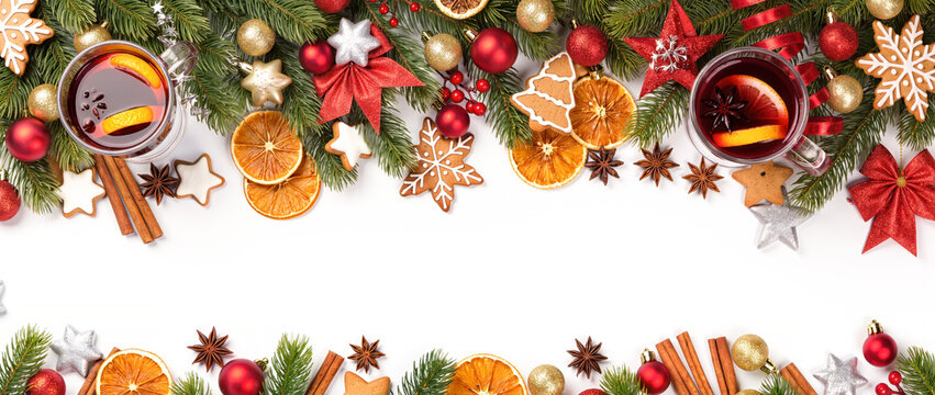 Christmas border with mulled wine, gingerbread cookies, fir branches, dried oranges, and ornaments on white background.