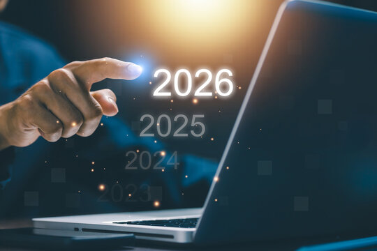 Businessman touching digital interface showing 2026 with previous years fading. Concept of future vision, innovation, and technology progress for business transformation and planning. - Powered by Adobe
