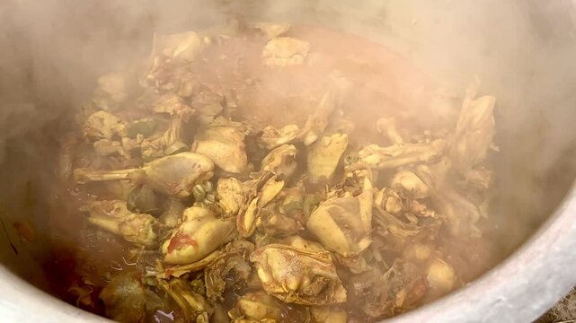 Slow Motion view of delicious Degi Style Chicken Kadhai Recip. A chef stirring spicy chicken karahi in a wok over open flame at kitchen. Delicious and Tasty Chicken Karahi. Beautiful 4K Footage.