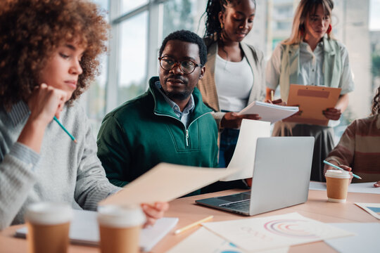 Diverse startup team collaborating during office meeting