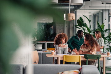 Diverse colleagues collaborating discussing project at modern office