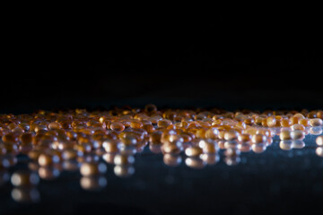 Macro shot capturing shimmering droplets on shiny surface