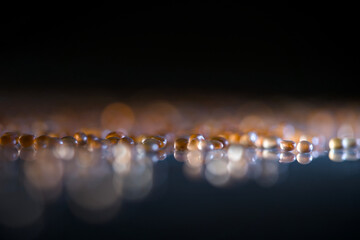 Macro shot capturing shimmering droplets on shiny surface