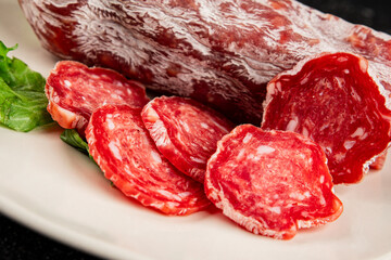 Dry sausage slice pork less fat jamon cured meat natural product tasty snack fresh delicious gourmet food background on the table rustic top view copy space