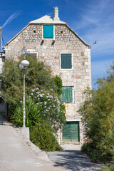 Charming Stone House With Blue Shutters In Sunny Coastal Village Setting