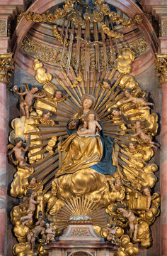 SALZBURG, AUSTIRA - SEPTEMBER 7, 2025: The carved polychrome baroque altar with the renaissance Madonna in the church Franziskanerkirche by Michael Pacher (1435 &ndash; 1498).
