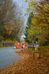 Rural road repair activities amid autumn landscape and subdued sky