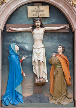SALZBURG, AUSTIRA - SEPTEMBER 7, 2025: The carved polychrome Crucifixion (Little calvary) in the church Erzabtei St. Peter by I. Piger from year 1886.