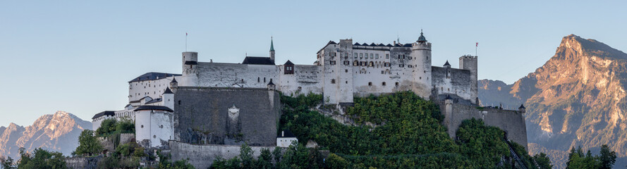 Fototapeta premium Salzburg - The panorama of castle Hohensalzburg with the alps in morning light.