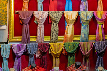 Colourful silk and other material fashion scarves accessories sold on market outside 