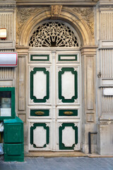 Old closed double vintage wooden entrance door on street exterior