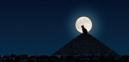 Silhouette of a cat atop a pyramid under a full moon at night