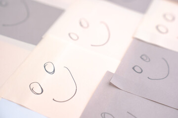 multi colored faces showing happy emotions on several closely placed post-its. Concept showing inclusion and diversity. horizontal format,