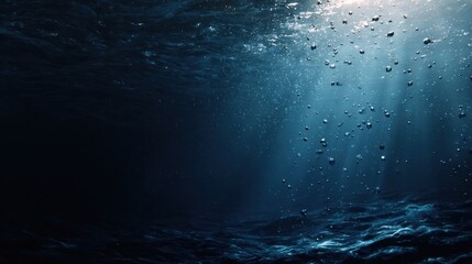 Underwater scene with sunlight and bubbles creating a dark atmospheric view