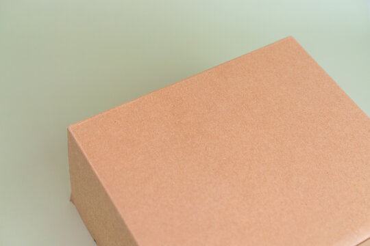 Mock-up of recycled eco friendly cardboard box, product and paracel packaging isolated on green background. Horizontal orientation with negative space for text