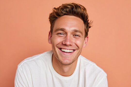 Cheerful man smiling against pastel background