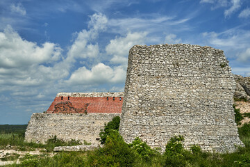 limestone rocks and fragment of a stone defensive wall of a medieval castle in Olsztyn