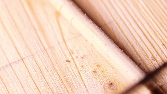 Sharp Blade Scraping Wood Shavings Perpendicularly to Shape Bamboo Stick, Close Up Hand Motion Detail, Carpentry Precision Action, Tool Efficiency, Material Texture Focus, Smooth Craftsmanship Movemen