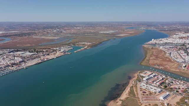 Drone flight over the Guadiana River between the banks of Vila Real Santo Antonio and the Spanish ci aerial drone flight over Guadiana River showcasing turquoise channel between Vila Real