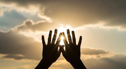 Silhouette hands framing bright sun rays through clouds light