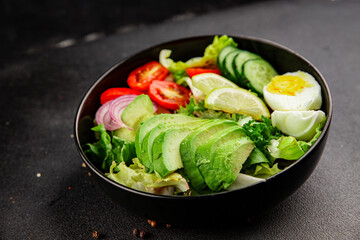 Avocado salad egg, tomato, onion, green leaf salad vegetable dish natural tasty snack fresh gourmet food background on the table rustic top view copy space keto and paleo diet vegan and vegan food