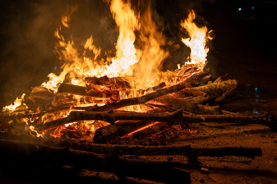 logs on fire for the hindu festival of holi lohri or a cremation pyre showing the celebration of this harvest festival across India
