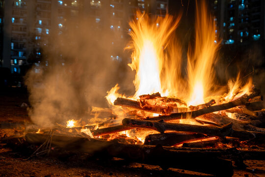 Long exposure shot of logs on fire with the flames smoothened out showing the celebration of the hindu festival of holi lohri by burning evil