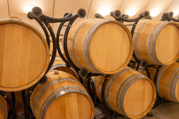 Visit of undergroud caves witn wine barrels for aging in Cahors wine production area, red malbec wines, wine tasting in chateau, France