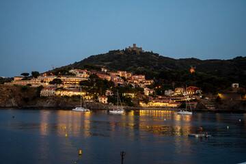 Night view on sea bay, lights and colourful houses of Collioure, Cote Vermeille, Pyrenees-Orientales, Occitania, France. Summer vacation destination