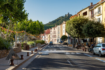 Fototapeta premium View of colourful Collioure, narrow streets and yellow, pink, orange houses, summer vacation destination town with historical buidings and beaches, Pyrenees-Orientales, France