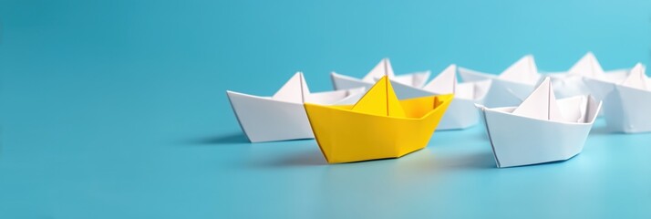 Boat paper concept yellow ship business leadership leader lead origami partnership. Background boat paper concept change journey success crew blue compass unique different fleet join team challenge