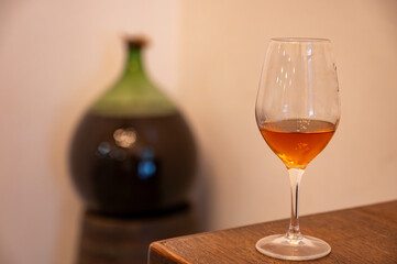 Tasting of Banyuls AOC aged natural sweet grand cru Banyuls fortified dessert wine from old vines from slopes Pyrenees in Roussillon, France made in glass jar Dame Jeanne or demijohn