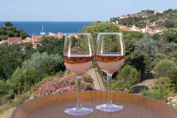Summer vacation on Mediterranean sea, drinking cold rose wine in glass in sunlights, Collioure,...