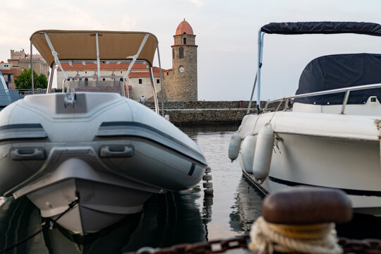 View of colourful Collioure, narrow streets and yellow, pink, orange houses, summer vacation destination town with historical buidings and beaches, Pyrenees-Orientales, France