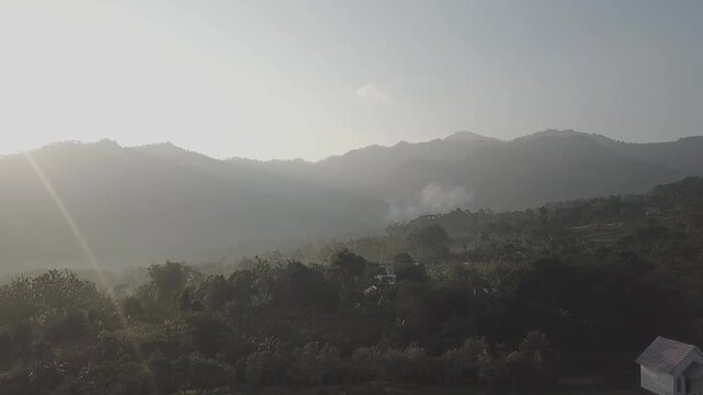 Bogor, Indonesia - November 06, 2025 : The contour of Mount Pancar looks majestic and green, standing quietly amidst the expanse of Bojong Koneng hills still covered in dew.