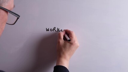 An HR business professional is writing Workplace Culture on a whiteboard in black marker pen, ideal for HR, recruitment, and business workplace presentations.