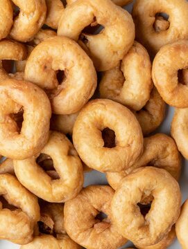 Delicious homemade snacks being prepared in a cozy kitchen with golden dough rings made from simple ingredients