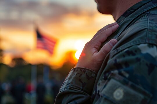 Soldier saluting during sunset with american flag in background