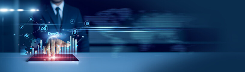 Businessman using tablet analyzing DevOps and growth graph chart, workflow automation. Continuous...