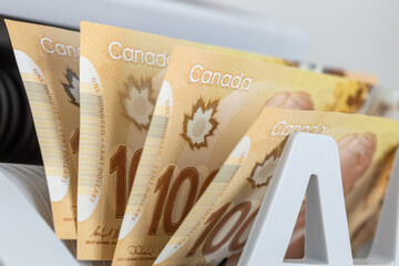 Canadian dollars in a bill counter. Financial concept. Canada money. Business background. Close up