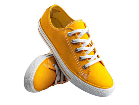 Yellow canvas sneakers with white laces isolated on transparent background