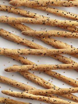 Freshly baked breadsticks with sesame sprinkled on top from a local bakery in the afternoon