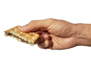Holding a chocolate filled cracker in hand, isolated on PNG background.