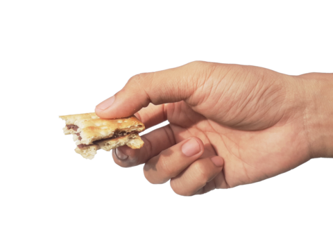 Holding a chocolate filled cracker in hand, isolated on PNG background.