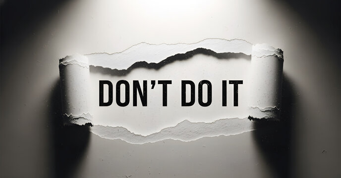 Don't do it text revealed through torn paper with dramatic spotlight