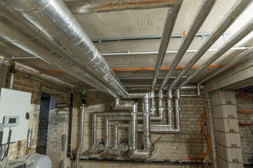 Industrial ventilation system with metallic ducts in a basement environment